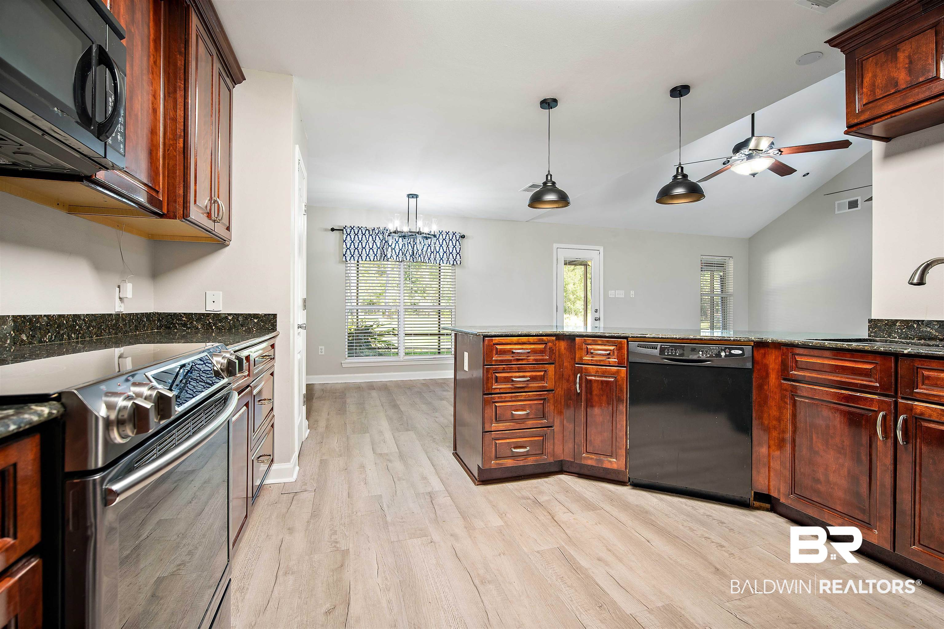 3010 Drag Strip Lane Coden, AL 36523 - Photo 13 of 44 Kitchen with sink, black appliances, light hardwood / wood-style flooring, pendant lighting, and vaulted ceiling