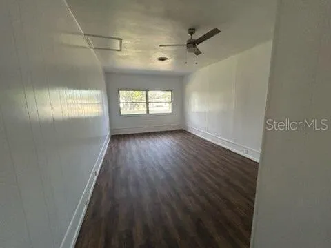 a view of a hallway to a livingroom with furniture