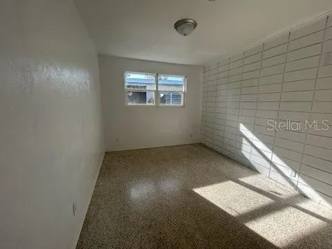 a bathroom with a granite countertop toilet and a bathtub