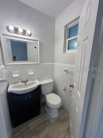 a bathroom with a sink toilet and mirror