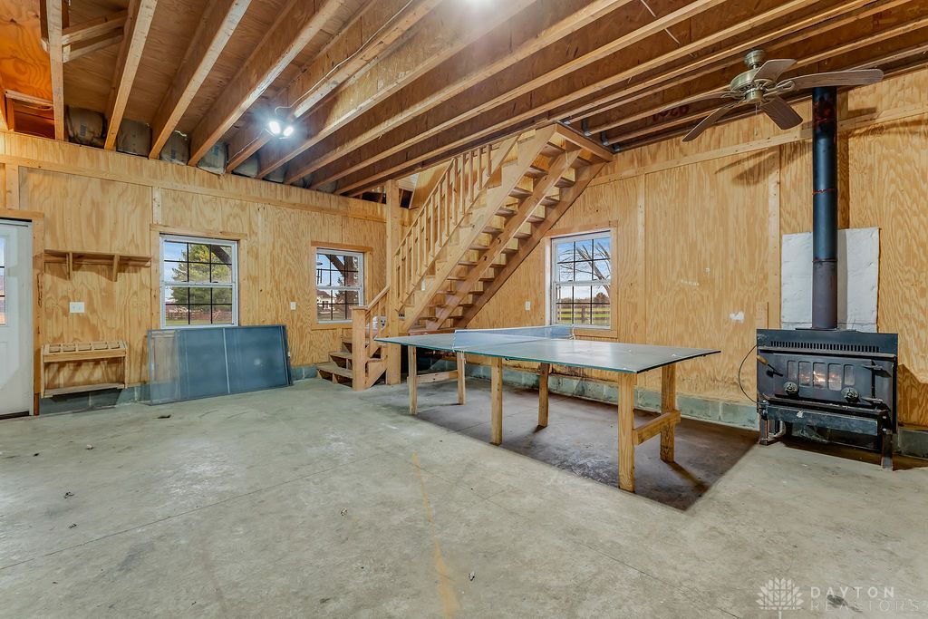 7400 Cook-Jones Road Waynesville, OH 45068 - Photo 62 of 72 This spacious interior offers exposed beam ceilings, a wood-burning stove, and ample room for recreation.
