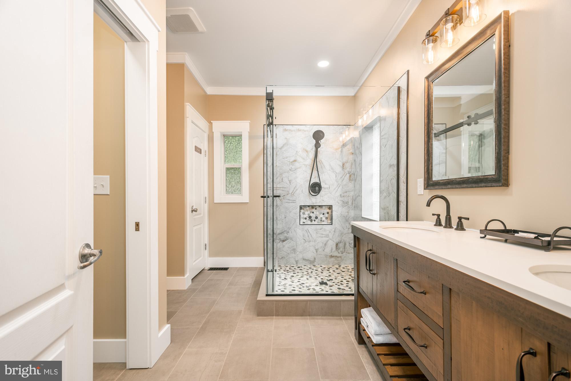 2228 Hoyes Run Road McHenry, MD 21541 - Photo 14 of 52 a spacious bathroom with a shower sink and a mirror