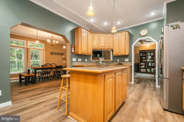 a kitchen with stainless steel appliances granite countertop a sink a stove and a refrigerator