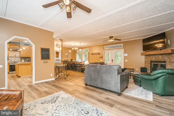 a living room with furniture a flat screen tv and a fireplace