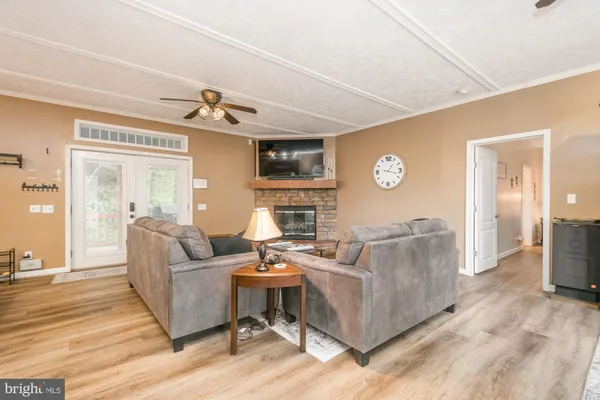 a living room with furniture a rug and white walls