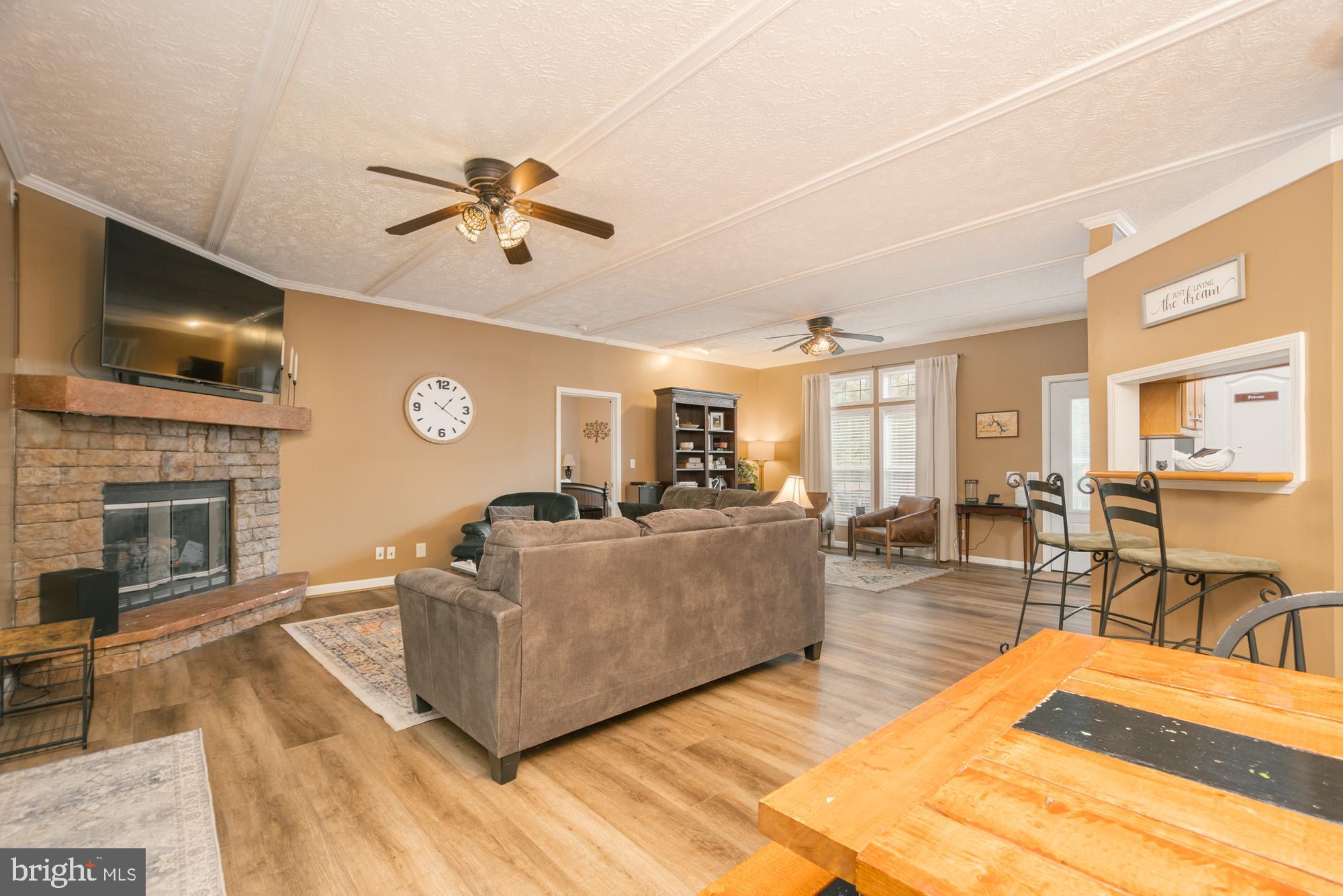 2228 Hoyes Run Road McHenry, MD 21541 - Photo 26 of 52 a living room with furniture a flat screen tv and a fireplace