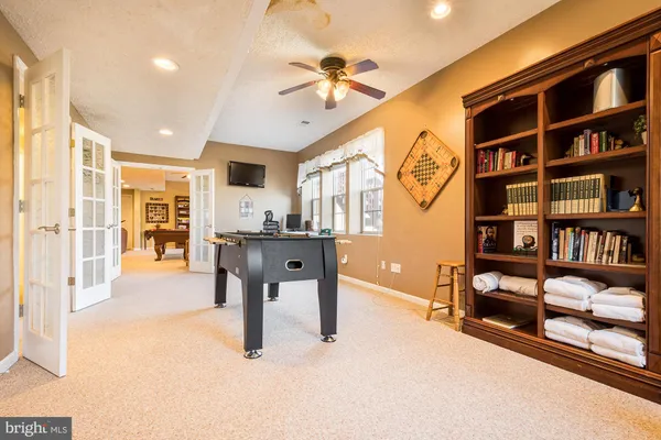 a living room with furniture a rug and white walls