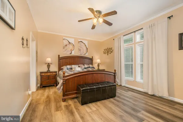 a bedroom with a bed a dresser and a flat screen tv