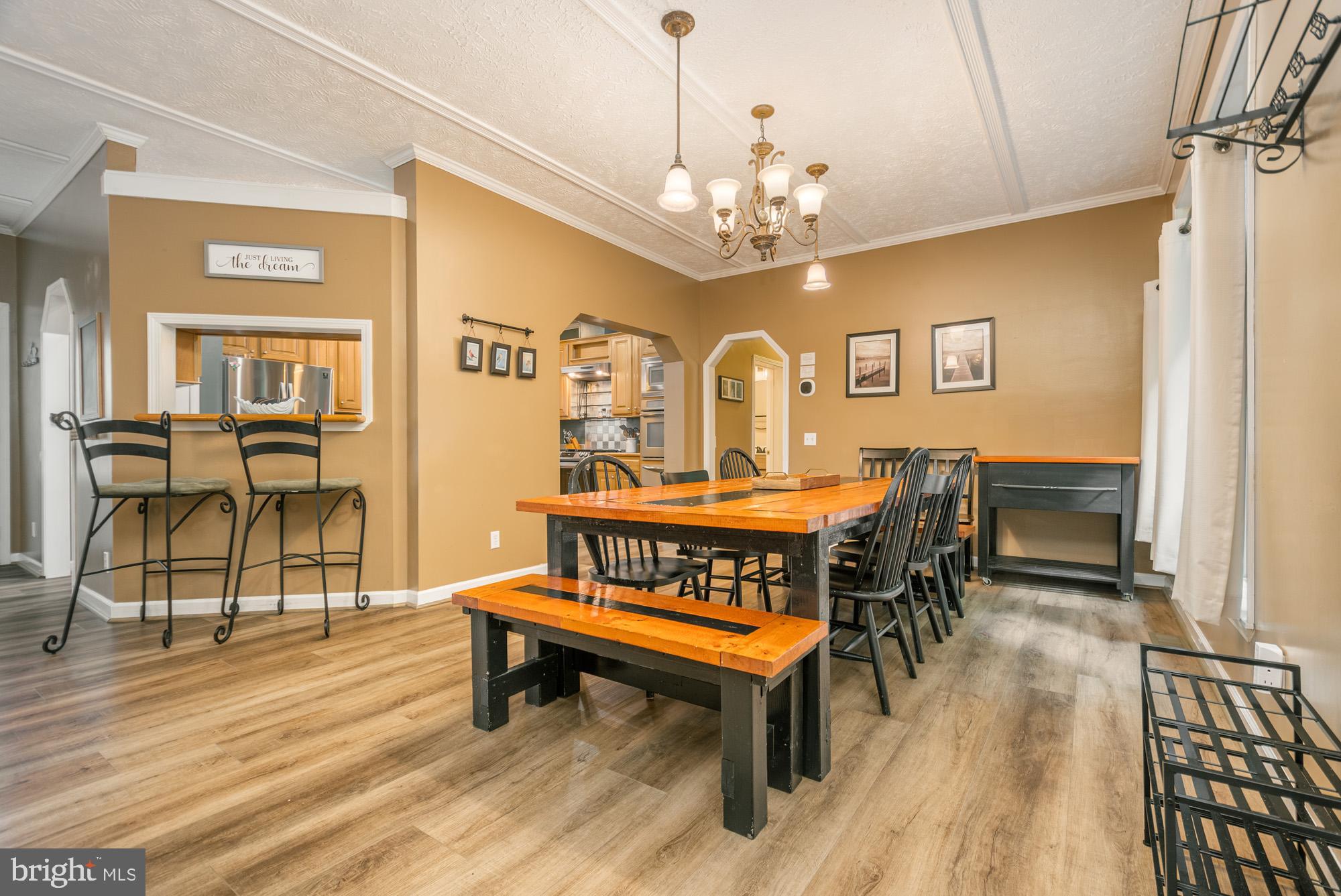 2228 Hoyes Run Road McHenry, MD 21541 - Photo 6 of 52 a dining room with furniture a chandelier and wooden floor