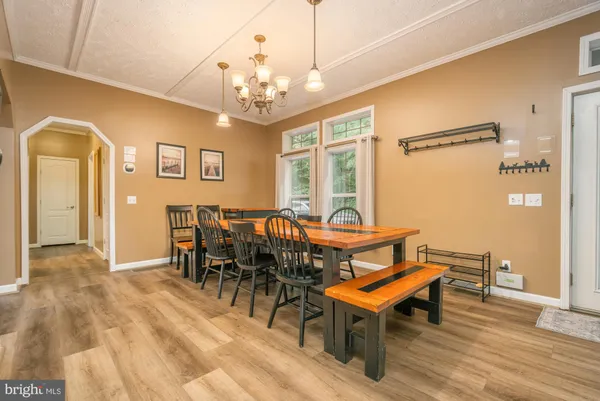 a view of a dining room with furniture and chandelier