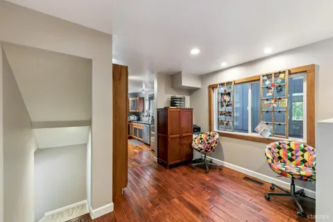a living room with furniture and a floor to ceiling window