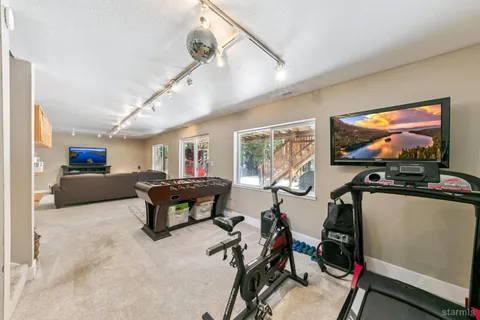 a living room with furniture a flat screen tv and a large window