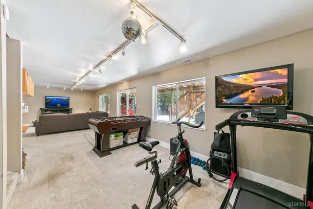 a living room with furniture a flat screen tv and a large window
