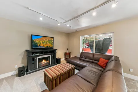 a living room with furniture a flat screen tv and a fireplace