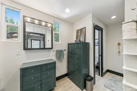 a bathroom with a sink a mirror and a shower