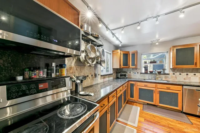 a kitchen with lots of counter top space and stainless steel appliances