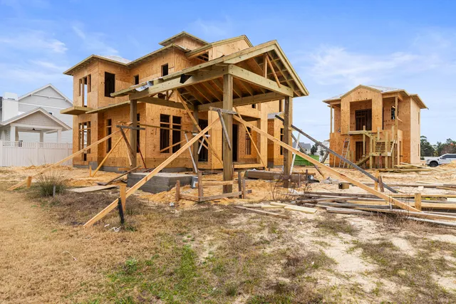 a kitchen with stainless steel appliances a stove top oven and a wooden floors