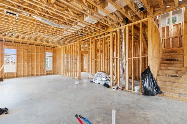 an aerial view of a house with a garden and covered with wooden fence