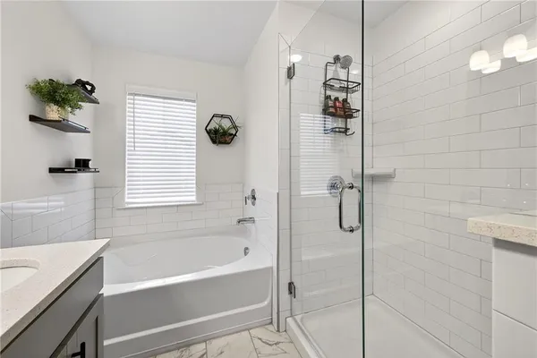 a bathroom with a bathtub shower and a window