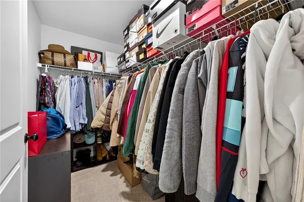 a view of walk in closet with clothes