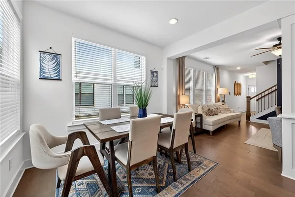 a dining room with furniture and wooden floor