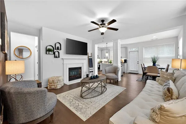 a living room with furniture a fireplace and a flat screen tv