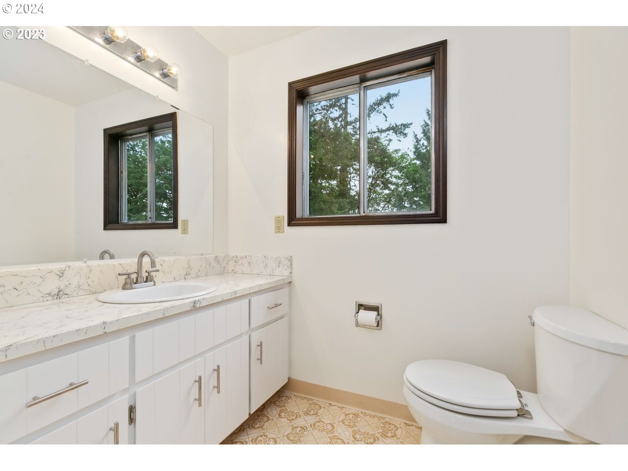 3318 Northwest 203rd Street Ridgefield, WA 98642 - Photo 20 of 28 a bathroom with a granite countertop toilet a sink and mirror
