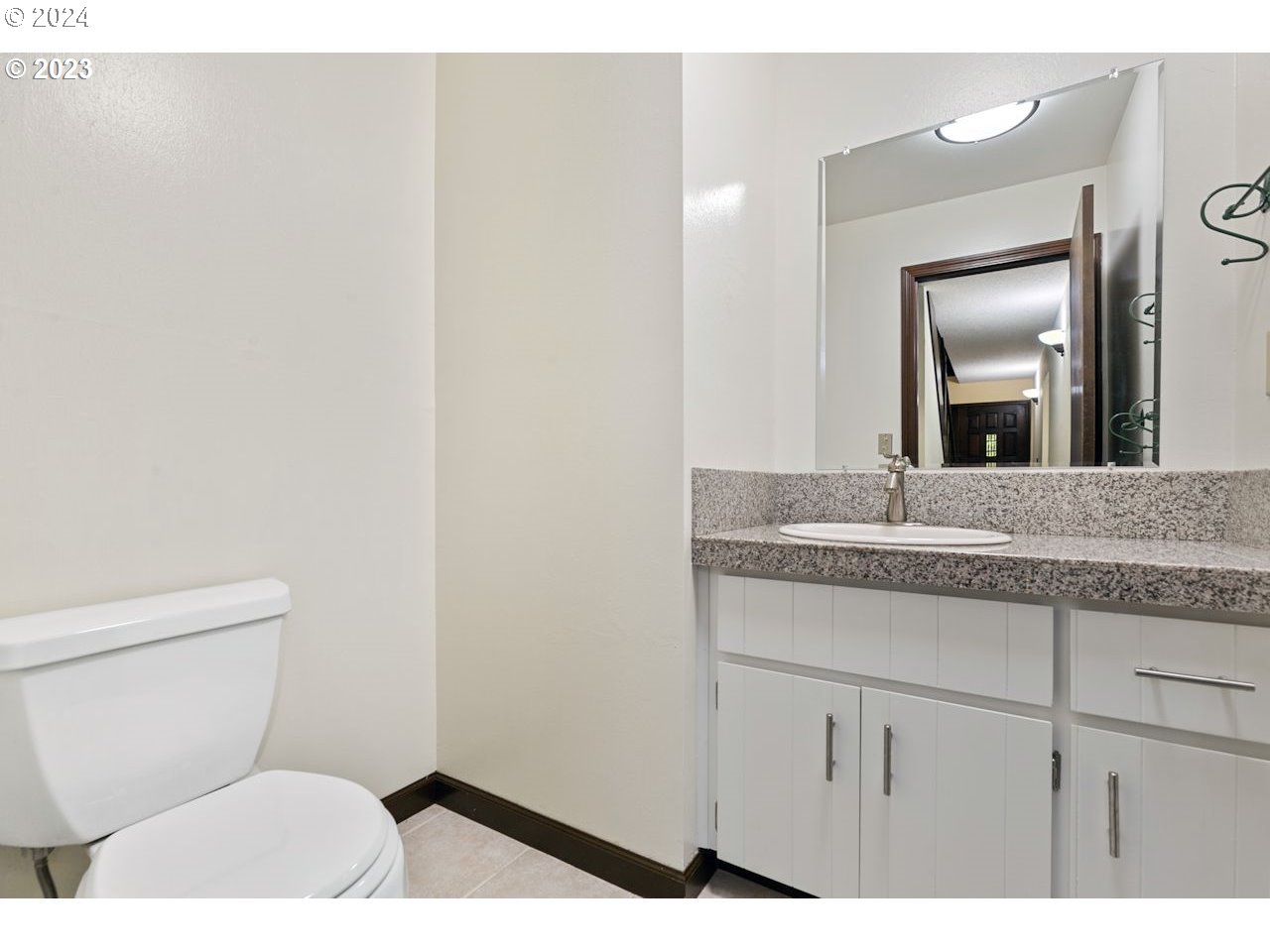 3318 Northwest 203rd Street Ridgefield, WA 98642 - Photo 3 of 28 a bathroom with a granite countertop sink a toilet and mirror