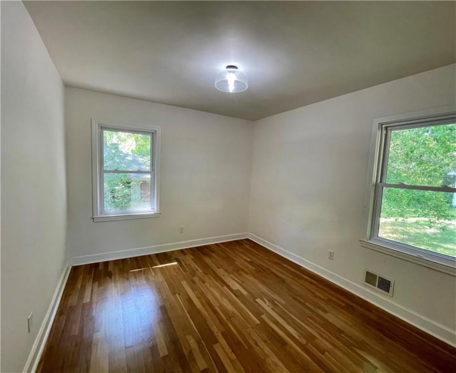 2682 Pineland Avenue Atlanta, GA 30340 - Photo 3 of 11 an empty room with wooden floor and windows