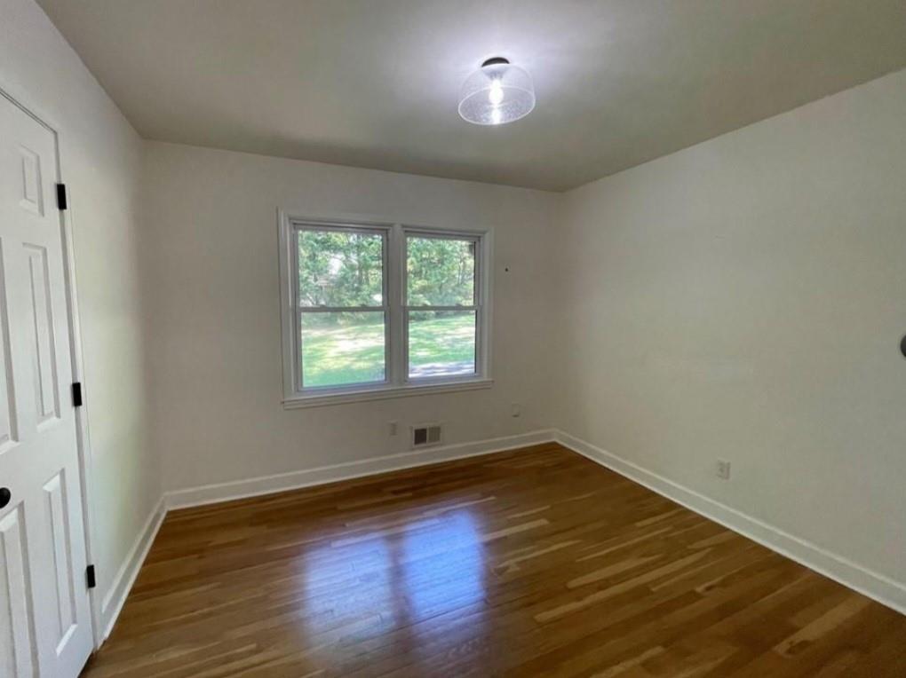 2682 Pineland Avenue Atlanta, GA 30340 - Photo 7 of 11 an empty room with wooden floor and windows