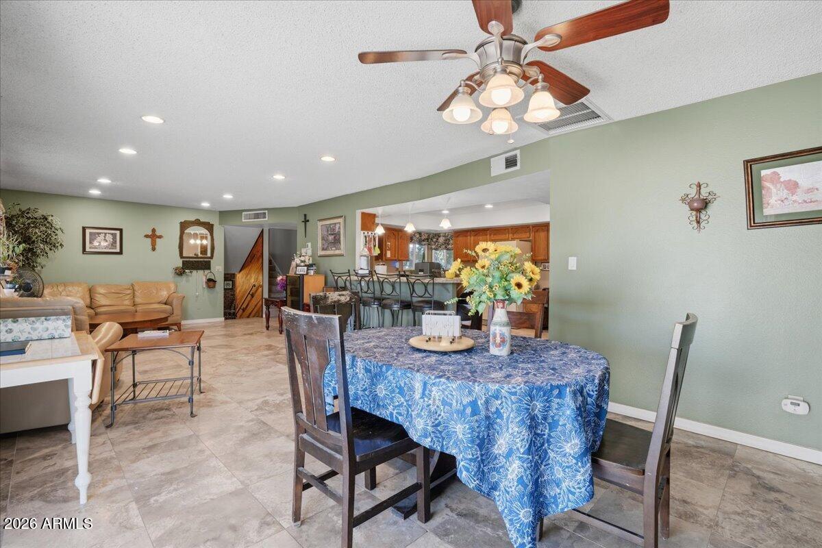 3922 South Poplar Street Tempe, AZ 85282 - Photo 13 of 41 a view of a dining room with furniture a chandelier and wooden floor