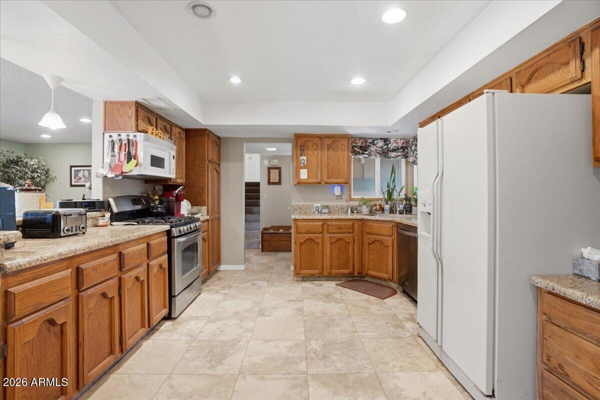 3922 South Poplar Street Tempe, AZ 85282 - Photo 15 of 41 a large kitchen with a large counter top space a sink stainless steel appliances and cabinets