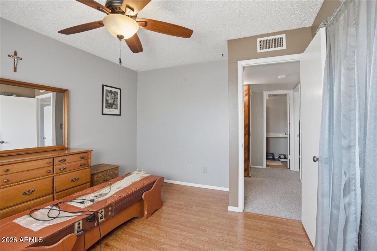 3922 South Poplar Street Tempe, AZ 85282 - Photo 32 of 41 a room with a bed and a chandelier
