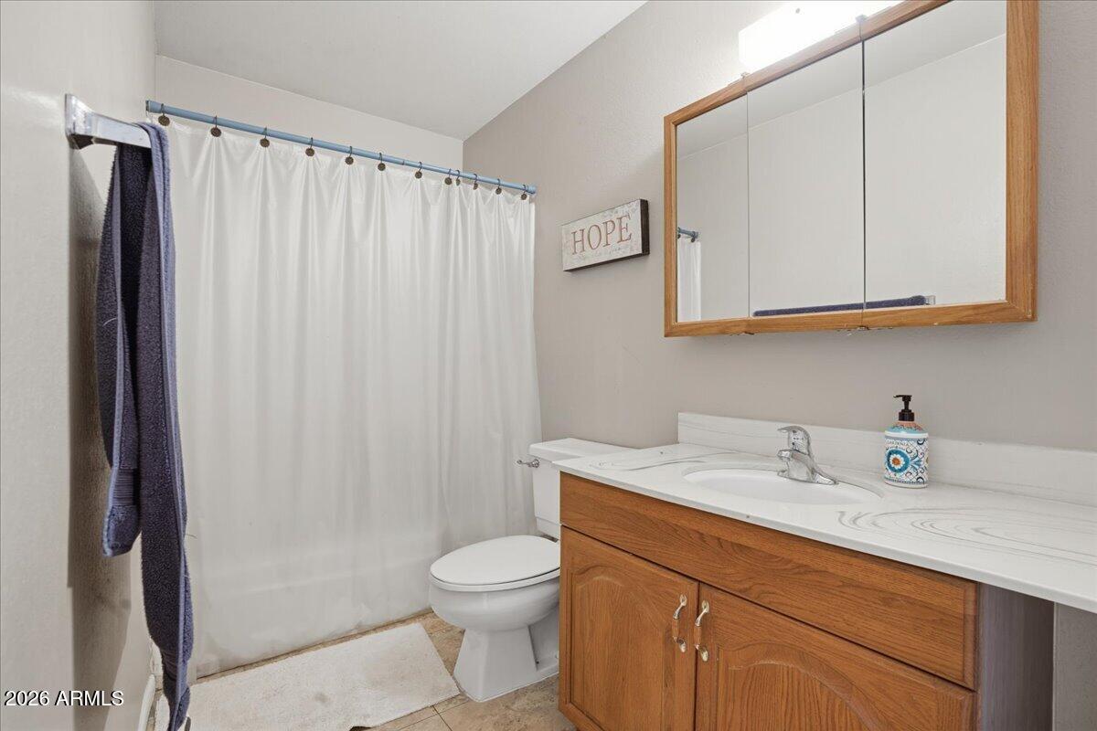 3922 South Poplar Street Tempe, AZ 85282 - Photo 33 of 41 a bathroom with a sink a toilet and vanity
