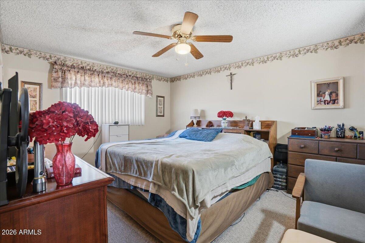 3922 South Poplar Street Tempe, AZ 85282 - Photo 34 of 41 a bedroom with bed and a chandelier