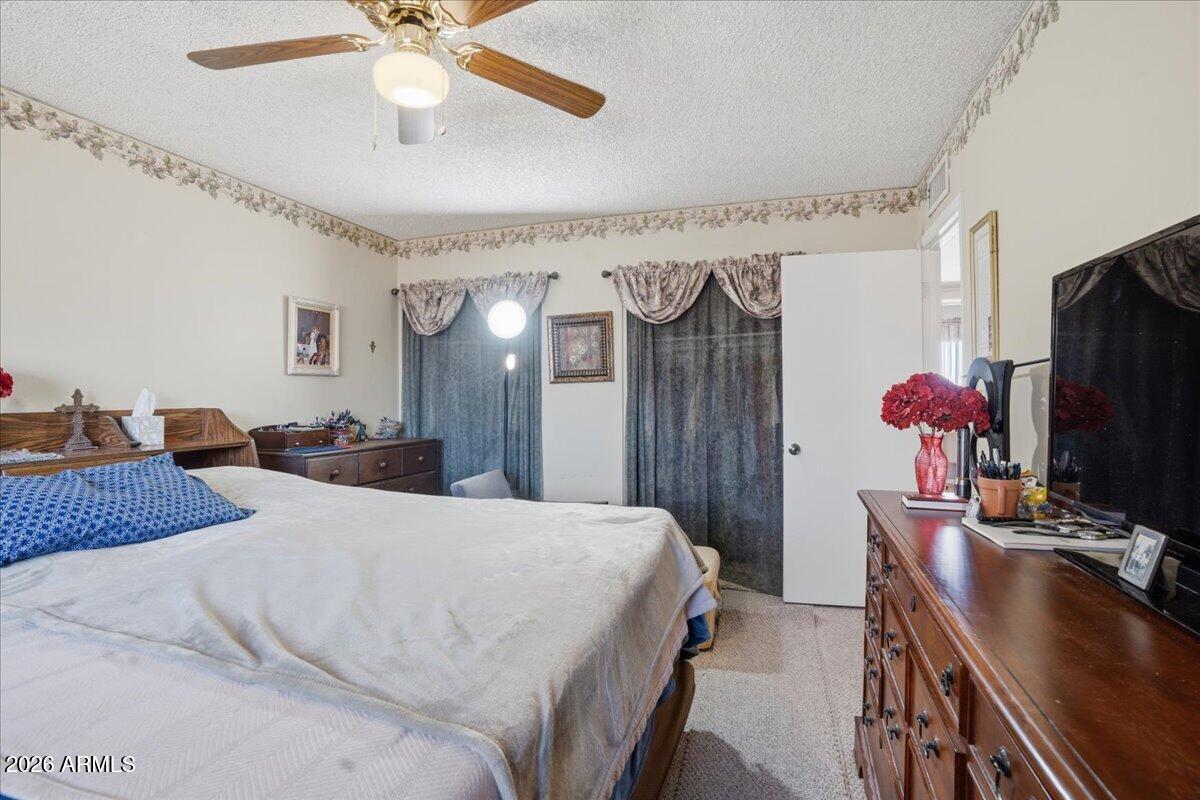 3922 South Poplar Street Tempe, AZ 85282 - Photo 35 of 41 a bedroom with a bed dresser and a flat tv screen
