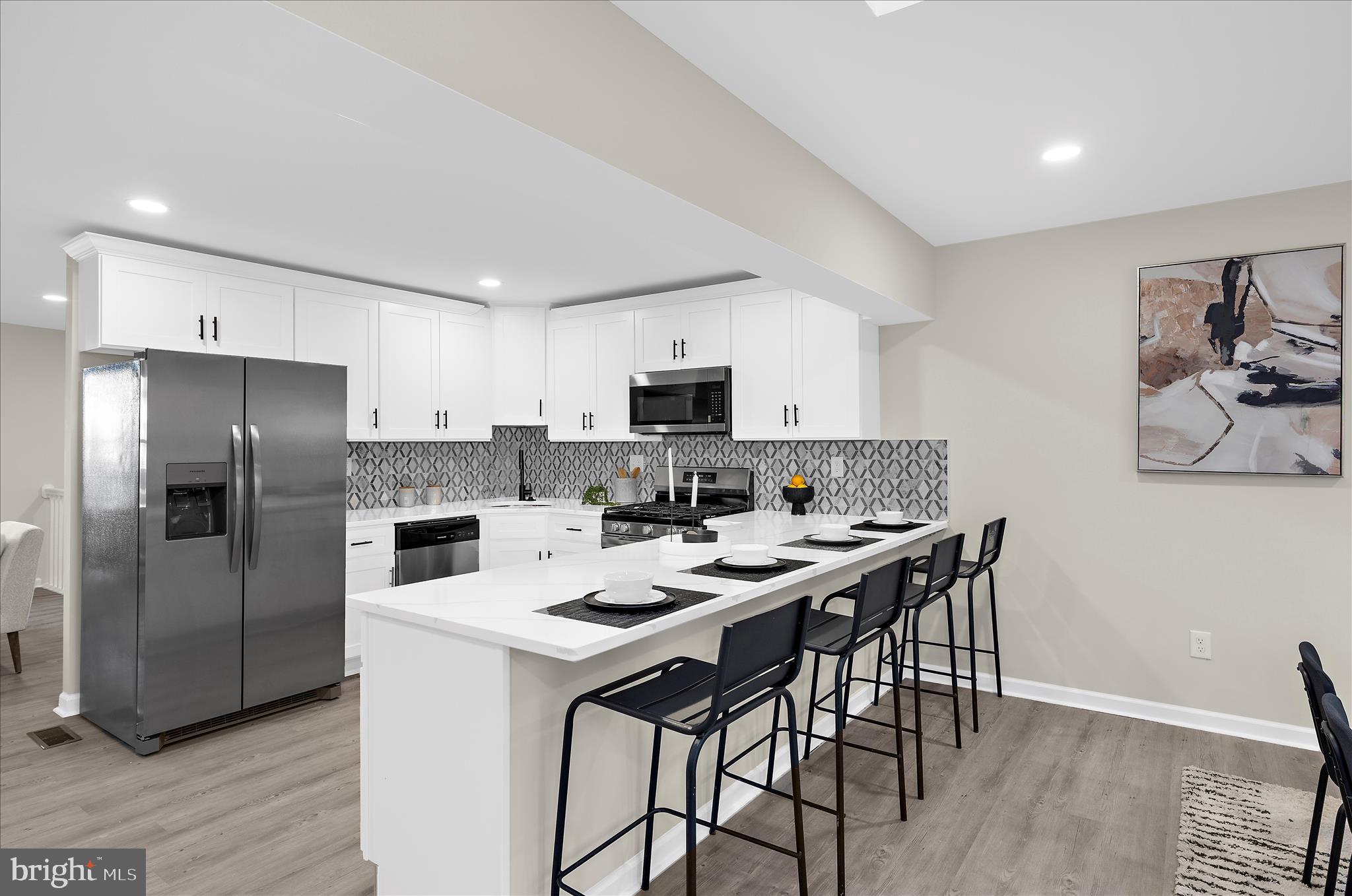 222 Doncaster Road Joppa, MD 21085 - Photo 7 of 41 a kitchen with stainless steel appliances a table and chairs