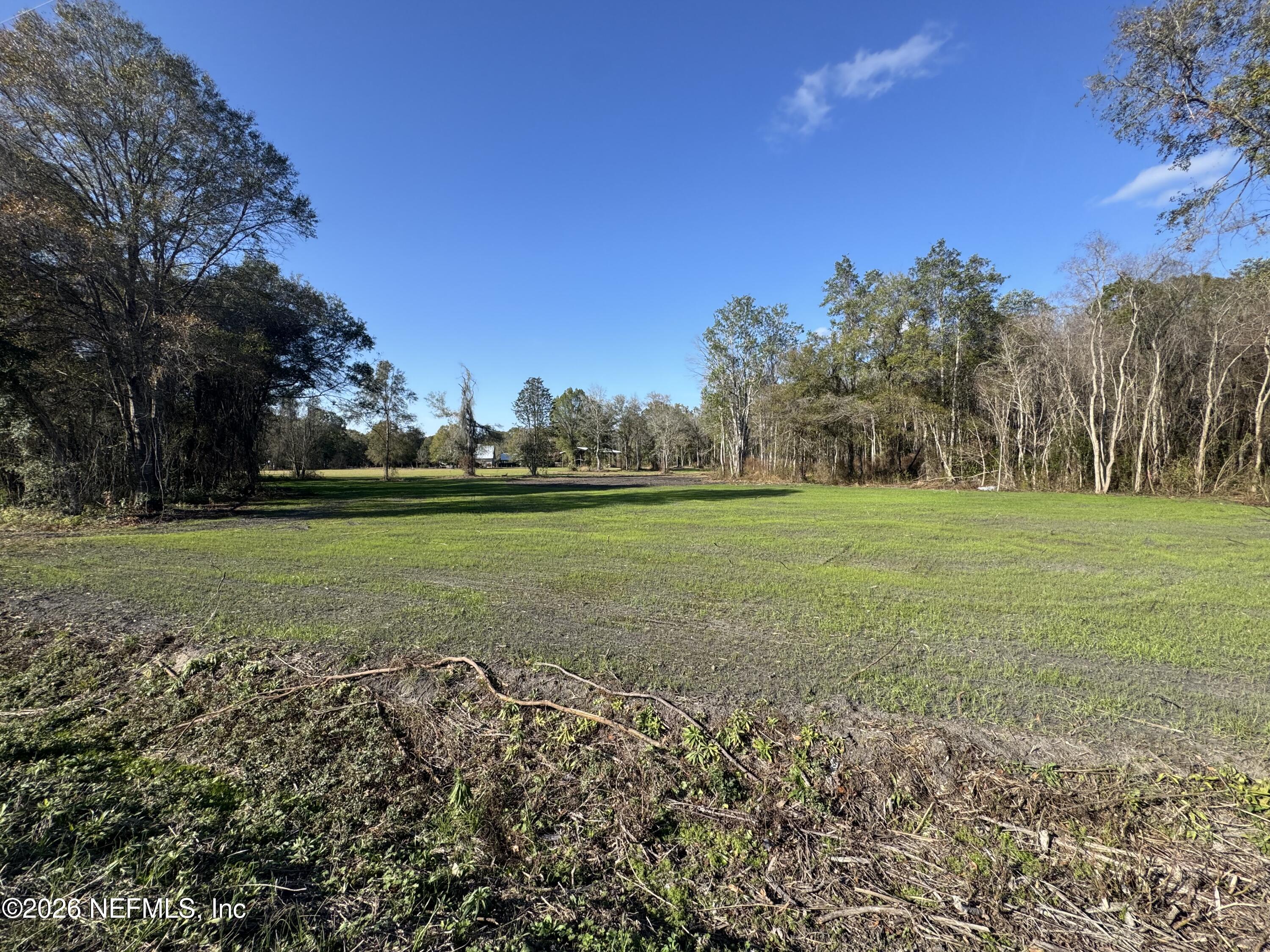 0 Northwest 185th Street Starke, FL 32091 - Photo 8 of 8 a view of a field with trees in the background