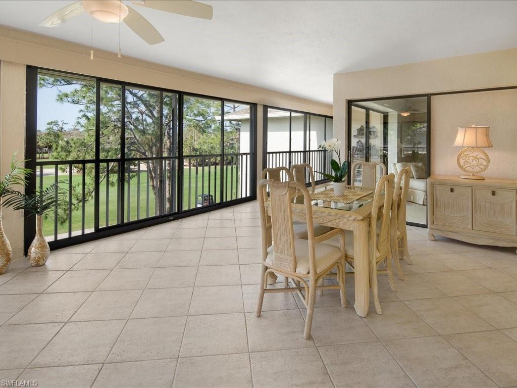 770 Eagle Creek Drive, Unit 301 Naples, FL 34113 - Photo 11 of 46 a dining room with furniture and large windows