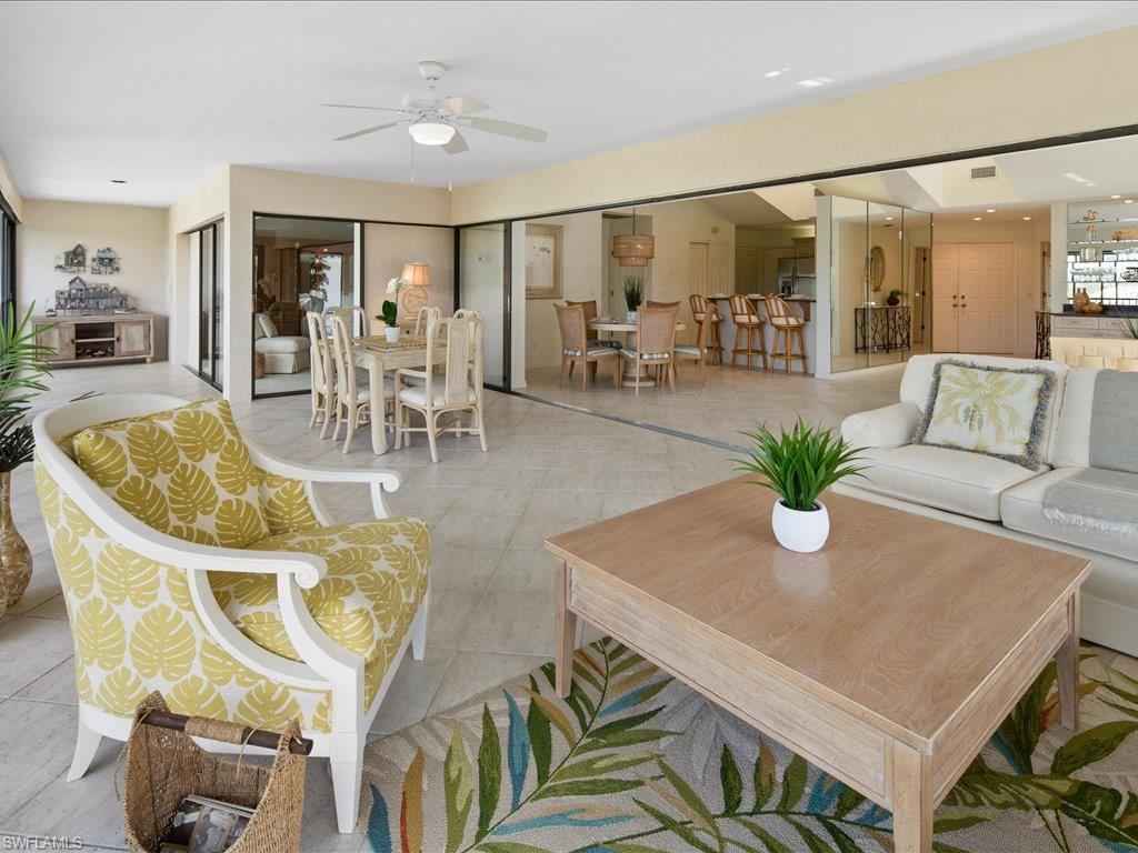 770 Eagle Creek Drive, Unit 301 Naples, FL 34113 - Photo 14 of 46 a dining room with furniture and wooden floor