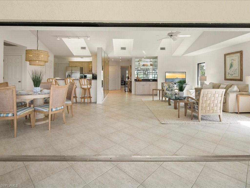 770 Eagle Creek Drive, Unit 301 Naples, FL 34113 - Photo 15 of 46 a living room with lots of furniture and a large window