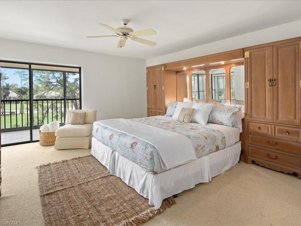 770 Eagle Creek Drive, Unit 301 Naples, FL 34113 - Photo 22 of 46 a bedroom with a large bed and a large window