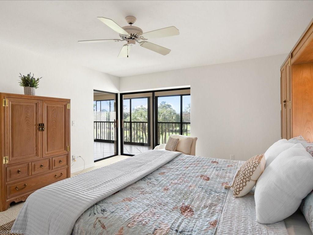 770 Eagle Creek Drive, Unit 301 Naples, FL 34113 - Photo 23 of 46 a bedroom with a large bed and a window
