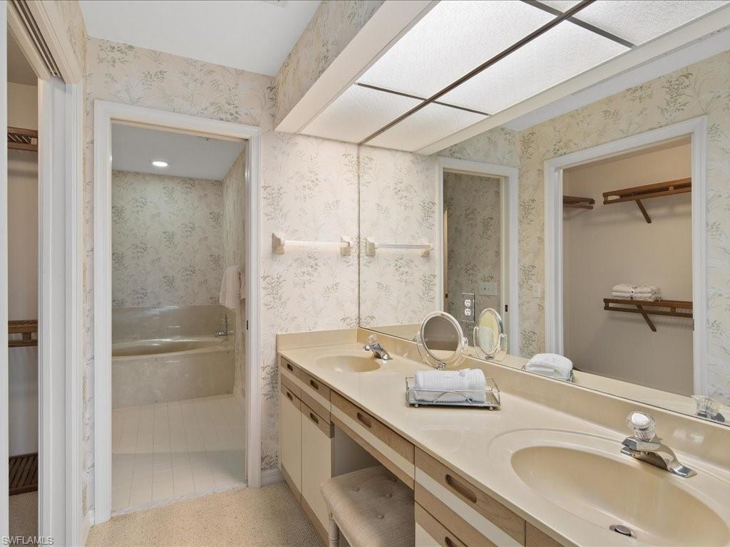 770 Eagle Creek Drive, Unit 301 Naples, FL 34113 - Photo 24 of 46 a bathroom with a granite countertop sink mirror and double