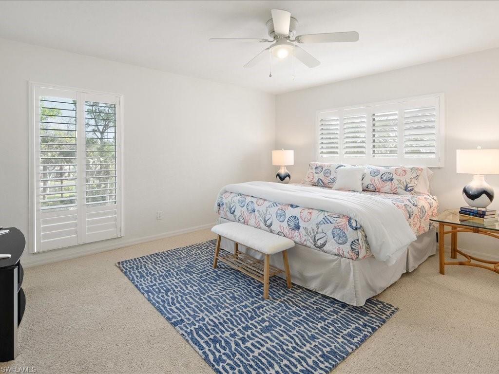 770 Eagle Creek Drive, Unit 301 Naples, FL 34113 - Photo 31 of 46 a spacious bedroom with a bed and a window