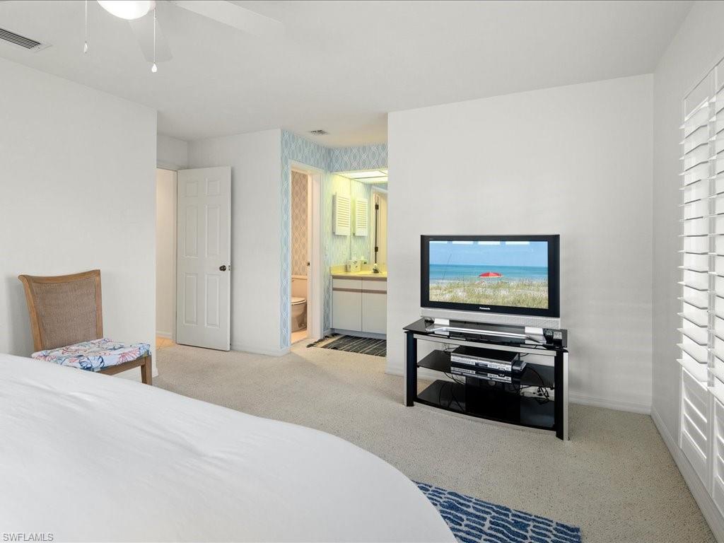 770 Eagle Creek Drive, Unit 301 Naples, FL 34113 - Photo 32 of 46 a bedroom with furniture and a window