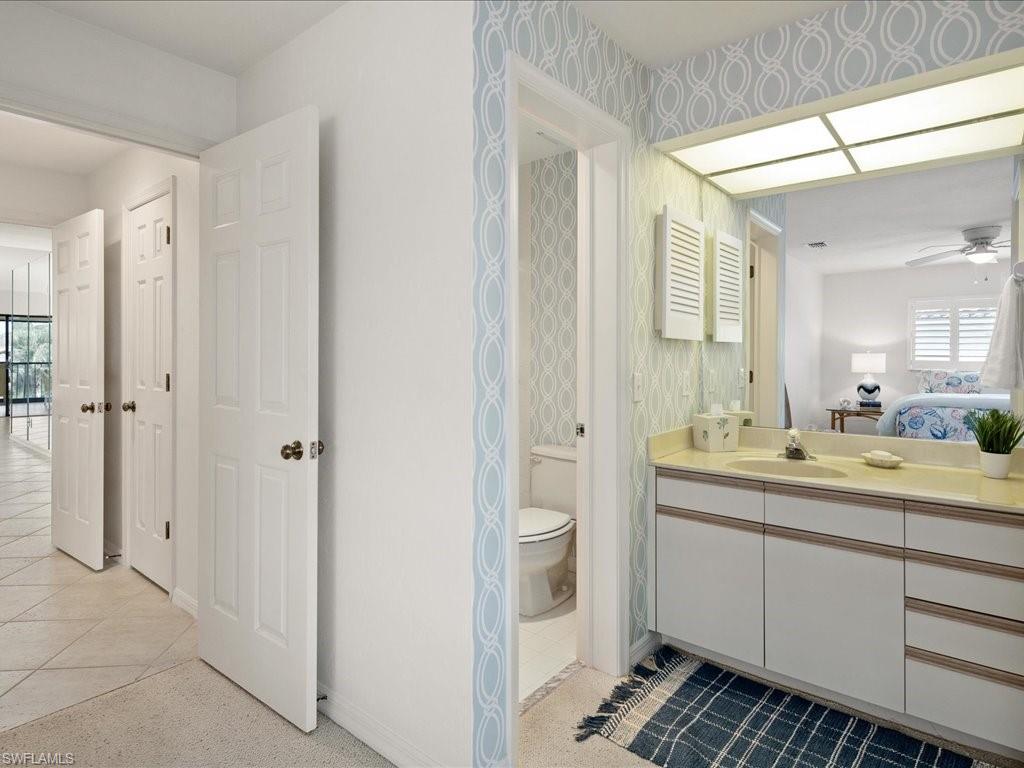 770 Eagle Creek Drive, Unit 301 Naples, FL 34113 - Photo 33 of 46 a bathroom with a double vanity sink and mirror