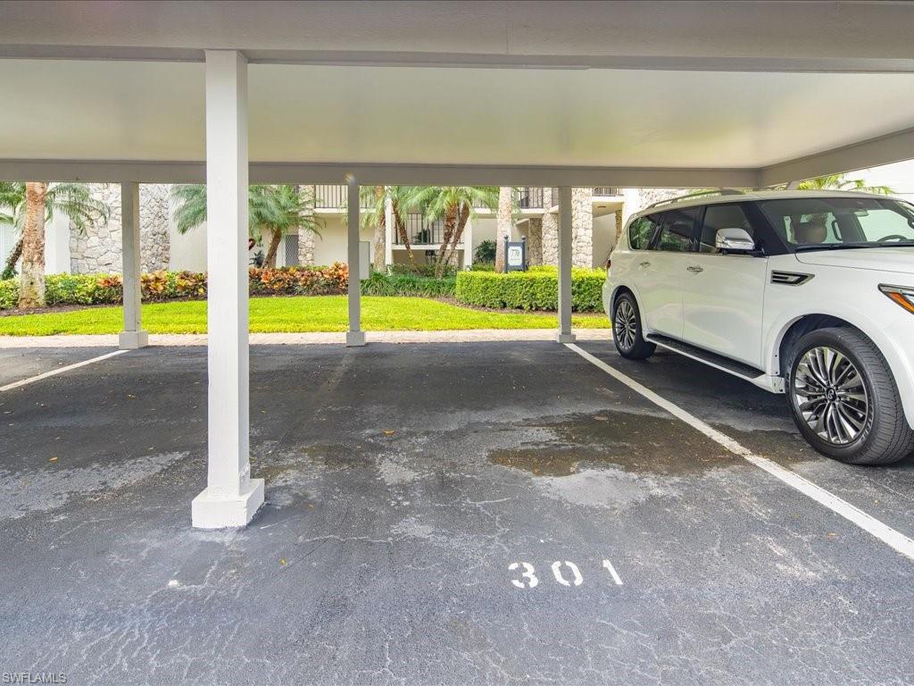 770 Eagle Creek Drive, Unit 301 Naples, FL 34113 - Photo 35 of 46 a view of a car park in front of a house
