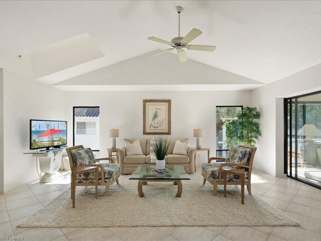 770 Eagle Creek Drive, Unit 301 Naples, FL 34113 - Photo 4 of 46 a living room with furniture and a large window