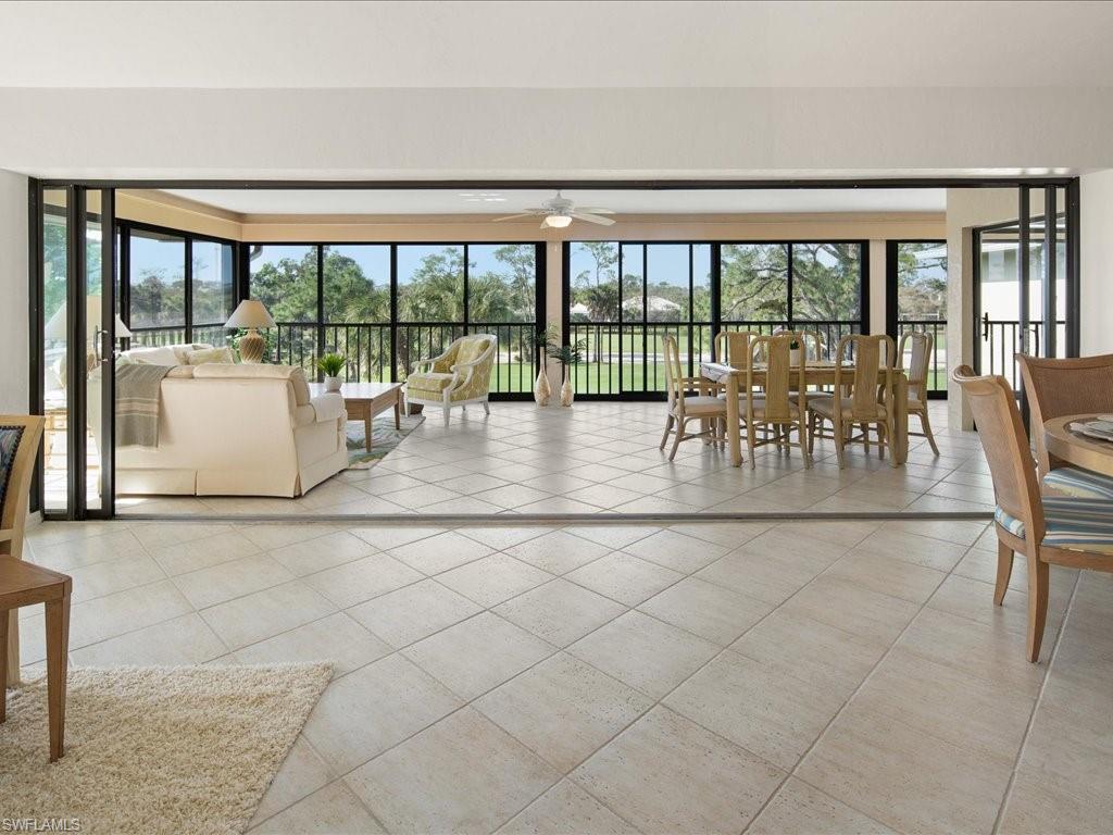 770 Eagle Creek Drive, Unit 301 Naples, FL 34113 - Photo 7 of 46 a living room with furniture and large windows